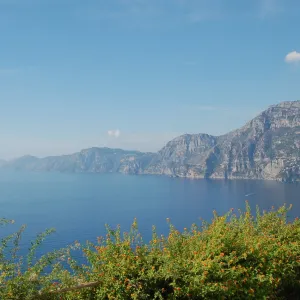 Landscape of mountains and water, greenery in the foreground