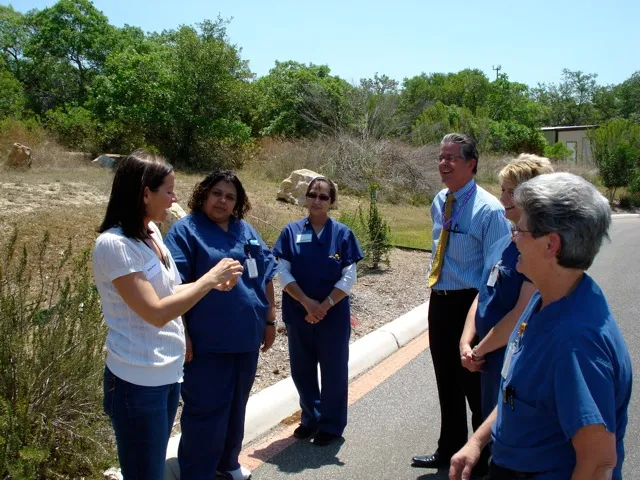 Group of people in blue shirts standing outside