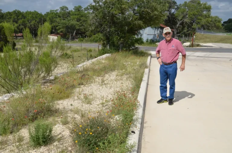 Man standing in front of a bed of native wildflowers